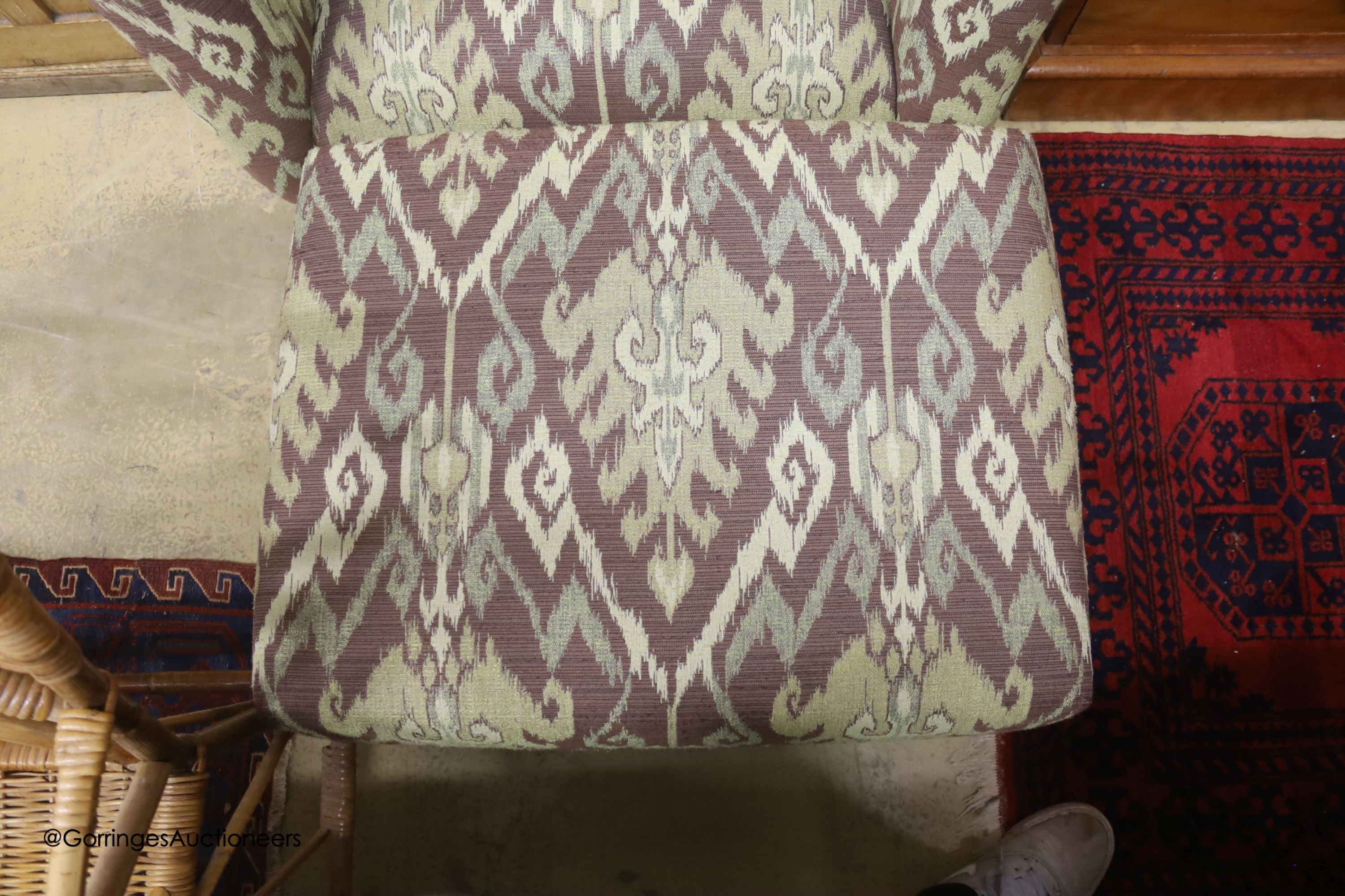 A Kelim upholstered armchair and matching footstool